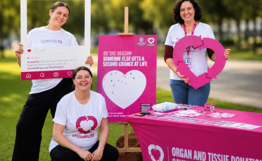 Three DonateLife volunteers at an information stand at the Adelaide Showground Farmers' Market during DonateLife Week.