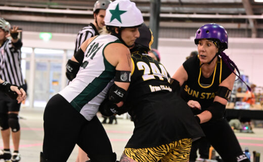 Roller derby players compete during the Great Southern Slam tournament at the Adelaide Showground, featuring teams from across Australia and New Zealand.