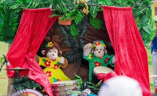 The Amazing Drumming Monkeys performing their colourful puppet show with drums on stage.