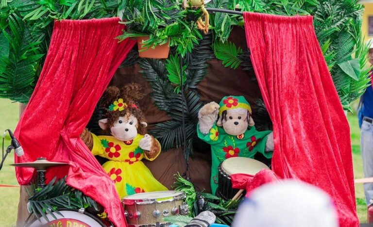 The Amazing Drumming Monkeys performing their colourful puppet show with drums on stage.